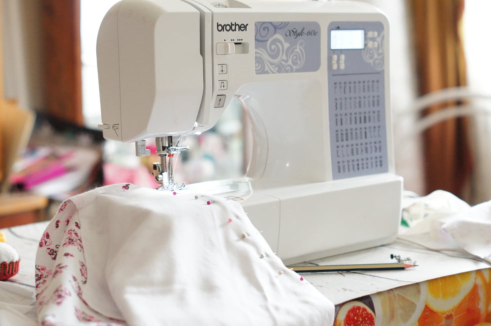 A Sewing Machine with Cloth on the Table